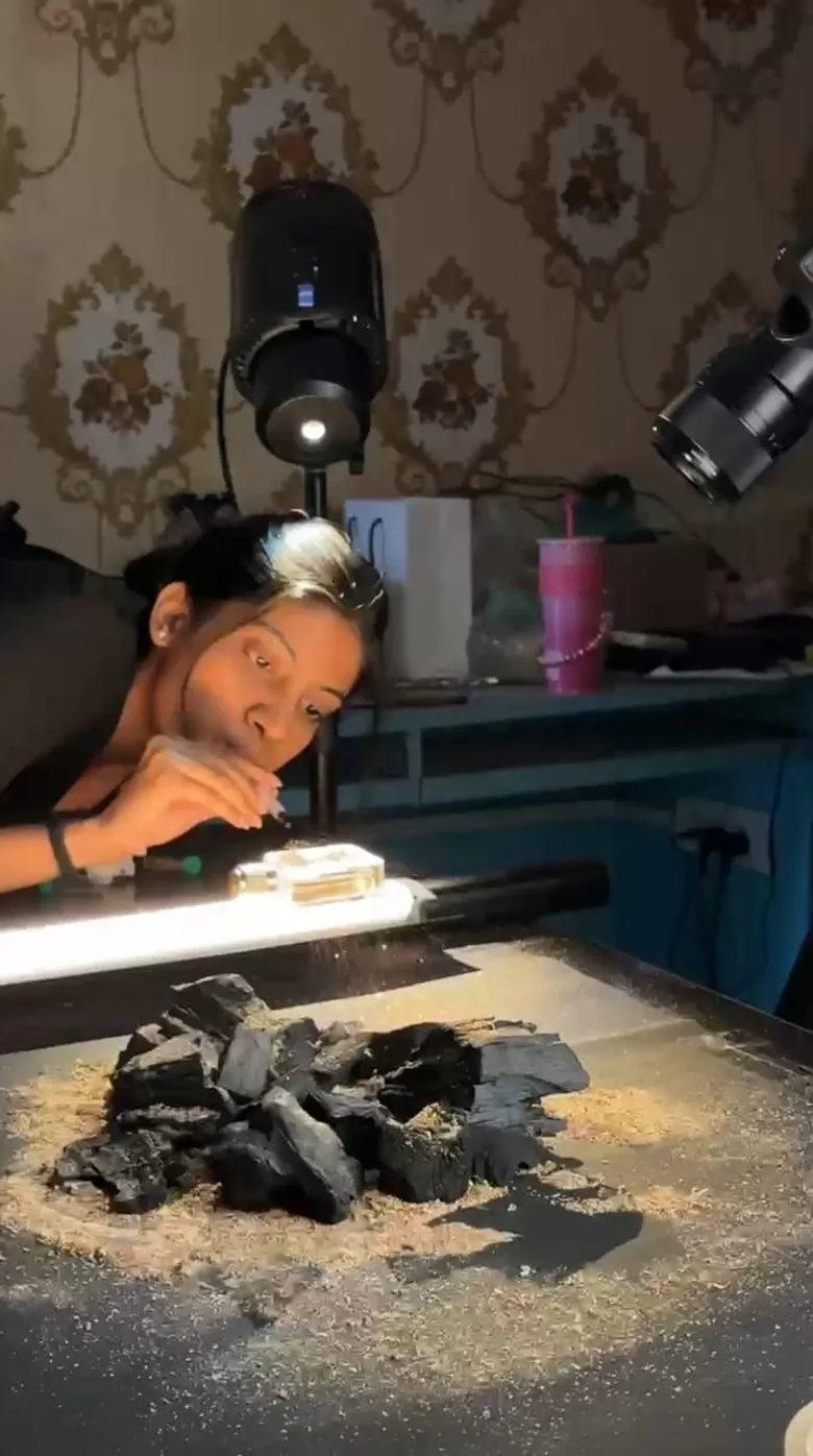 Tanisha fine-tuning physical textures and charcoal styling on set